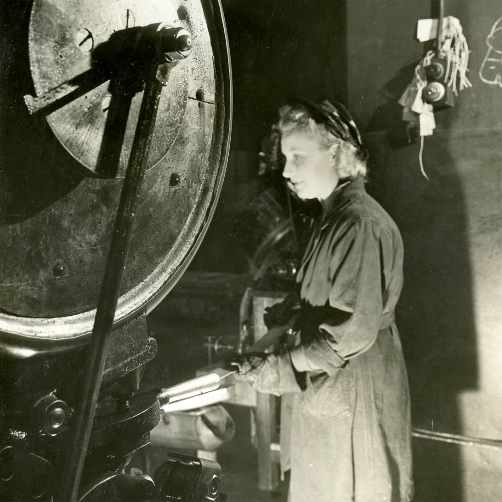 Woman working in cramped conditions in the Royal Mint factory