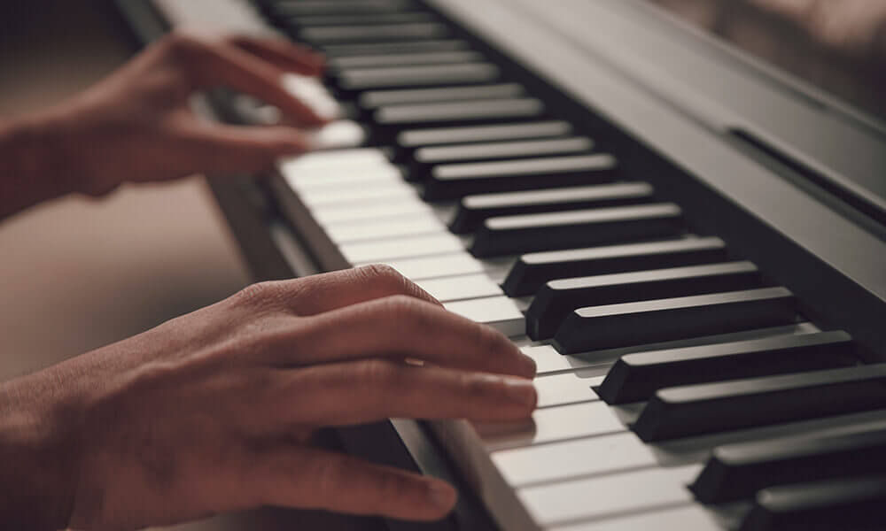 Hands playing a piano.jpg