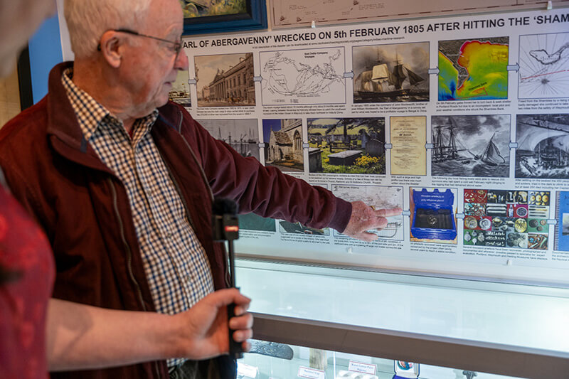 David Carter pointing at in inforgraphic at Portland Museum