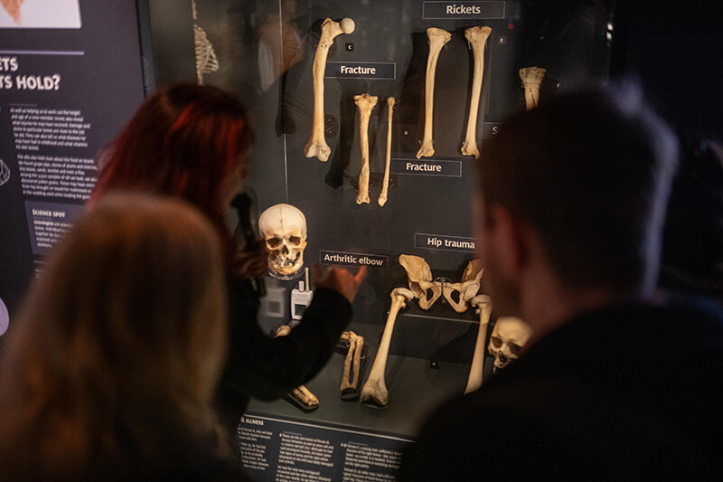 Hannah Matthews in front of a case at the Royal Mint Museum