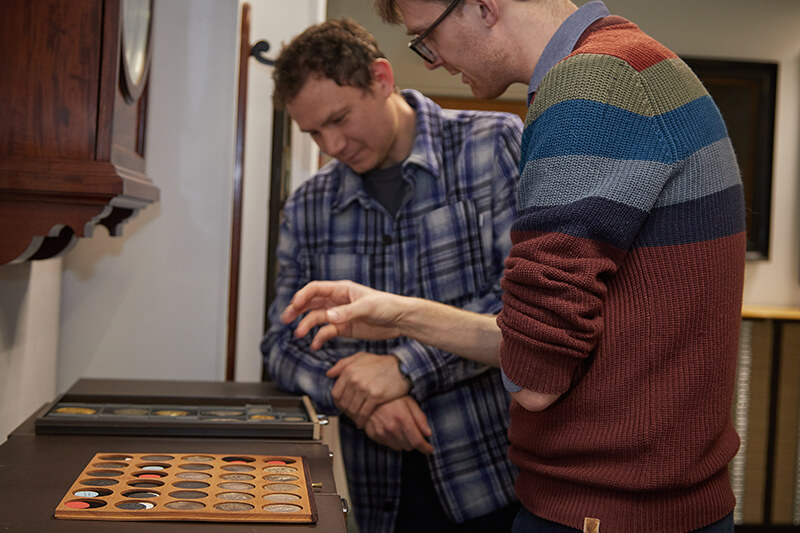 Chris Barker and Richard Blakemore looking at coins in the Royal Mint Museum